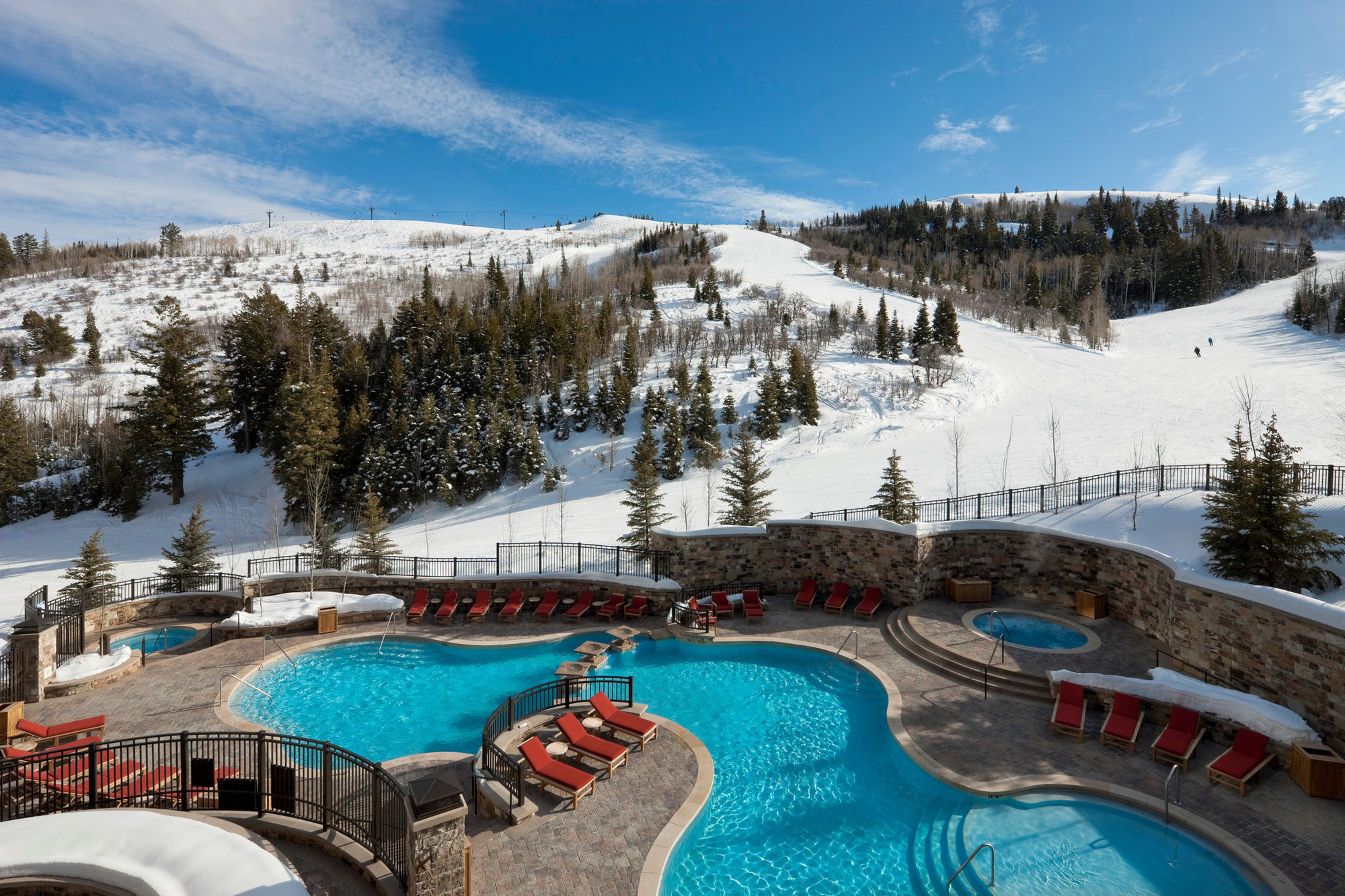 photo of outdoor pool with chairs surrounded by snow